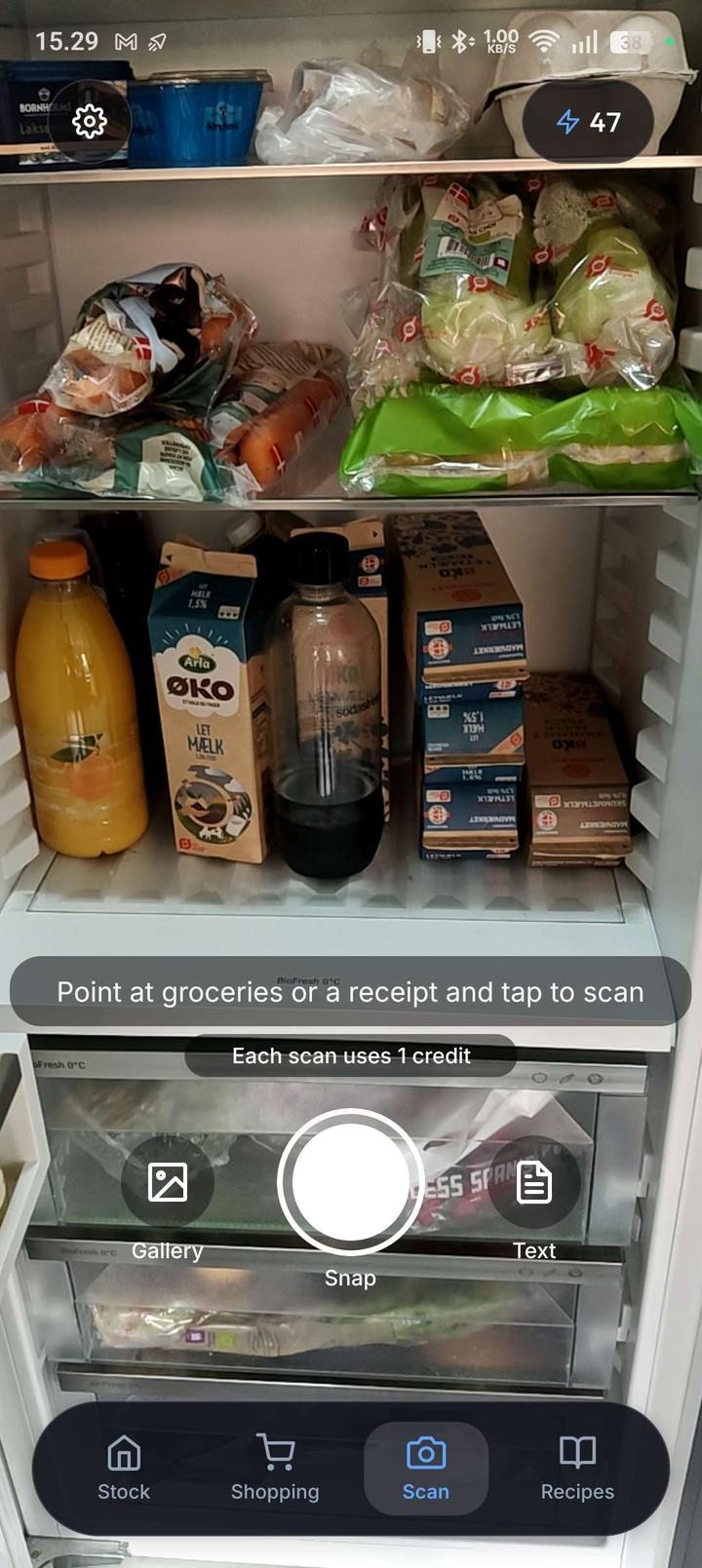 Stoxi camera scanner pointing at groceries inside a fridge with point-and-snap AI recognition